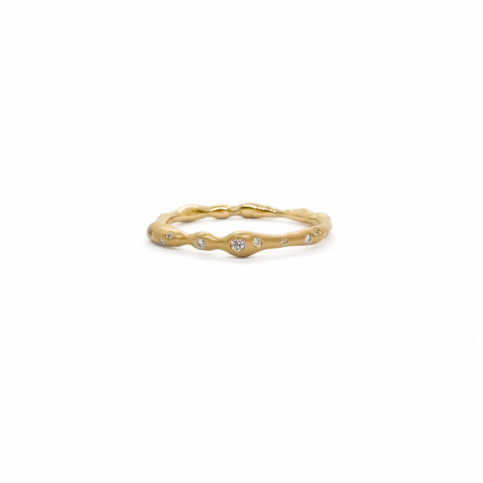 yellow golden organically shaped ring with diamonds