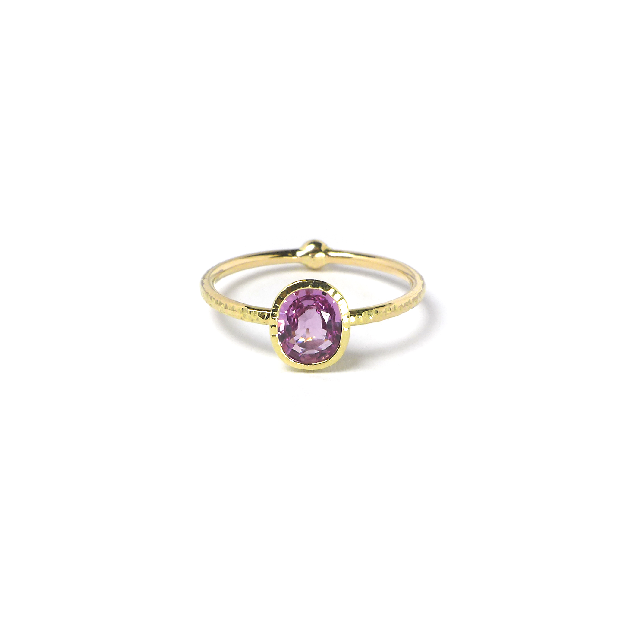 golden ring with a big pink sapphire stone