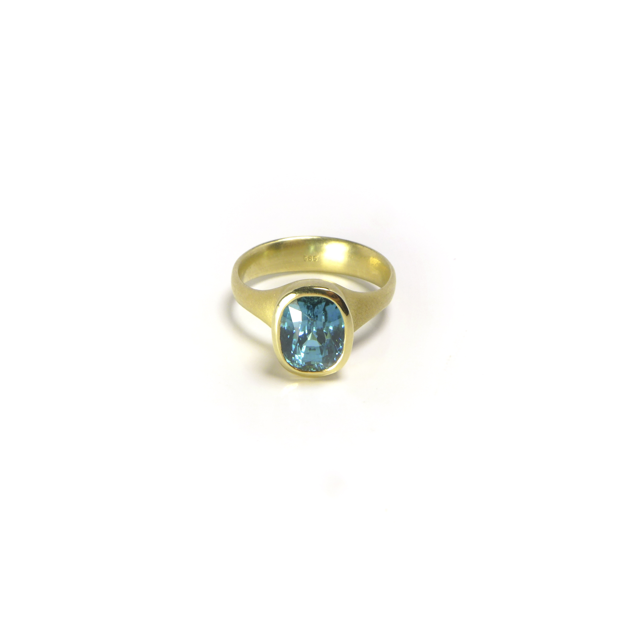 massive yellow gold ring with a blue antique-cut zirkon