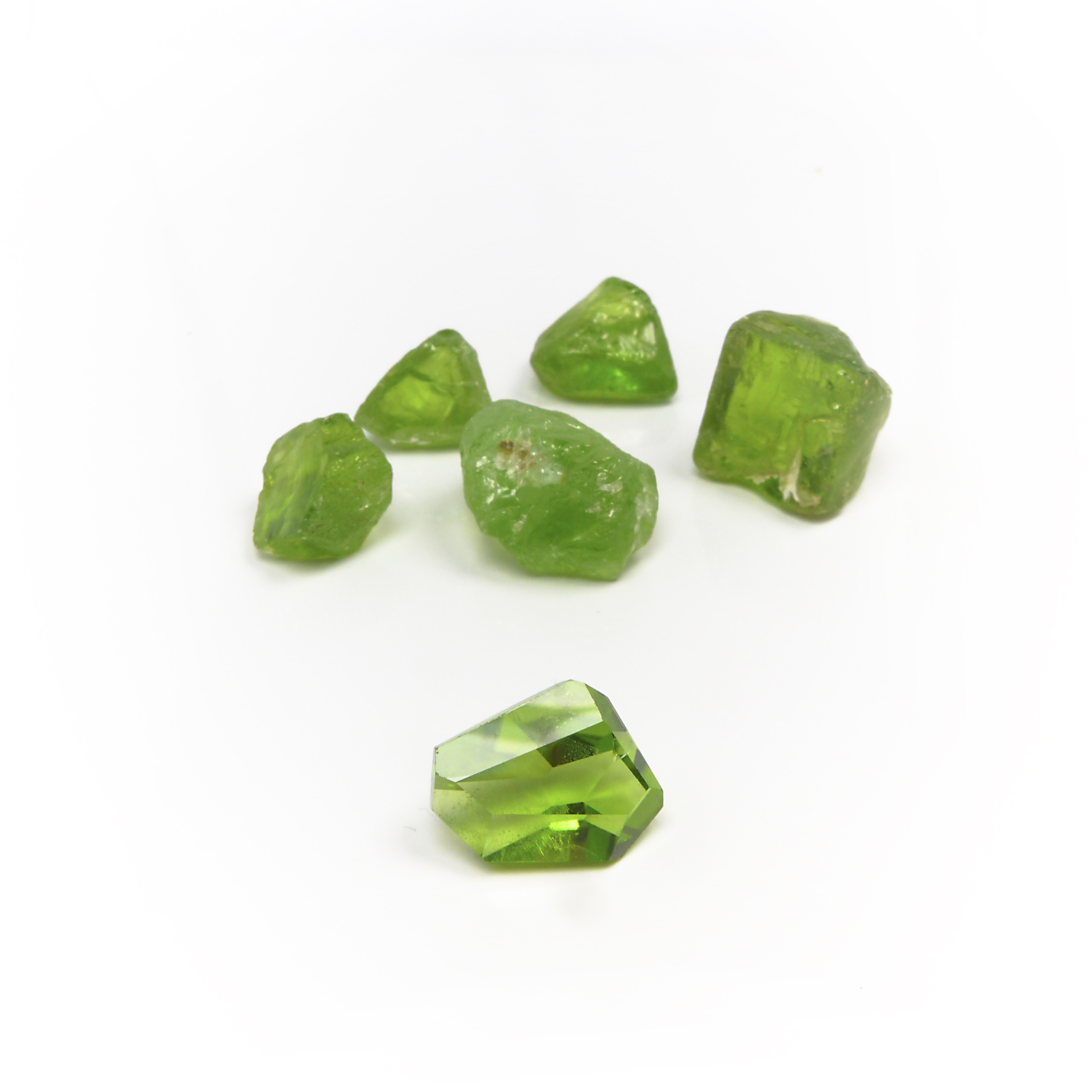 cut and rough green peridot stones