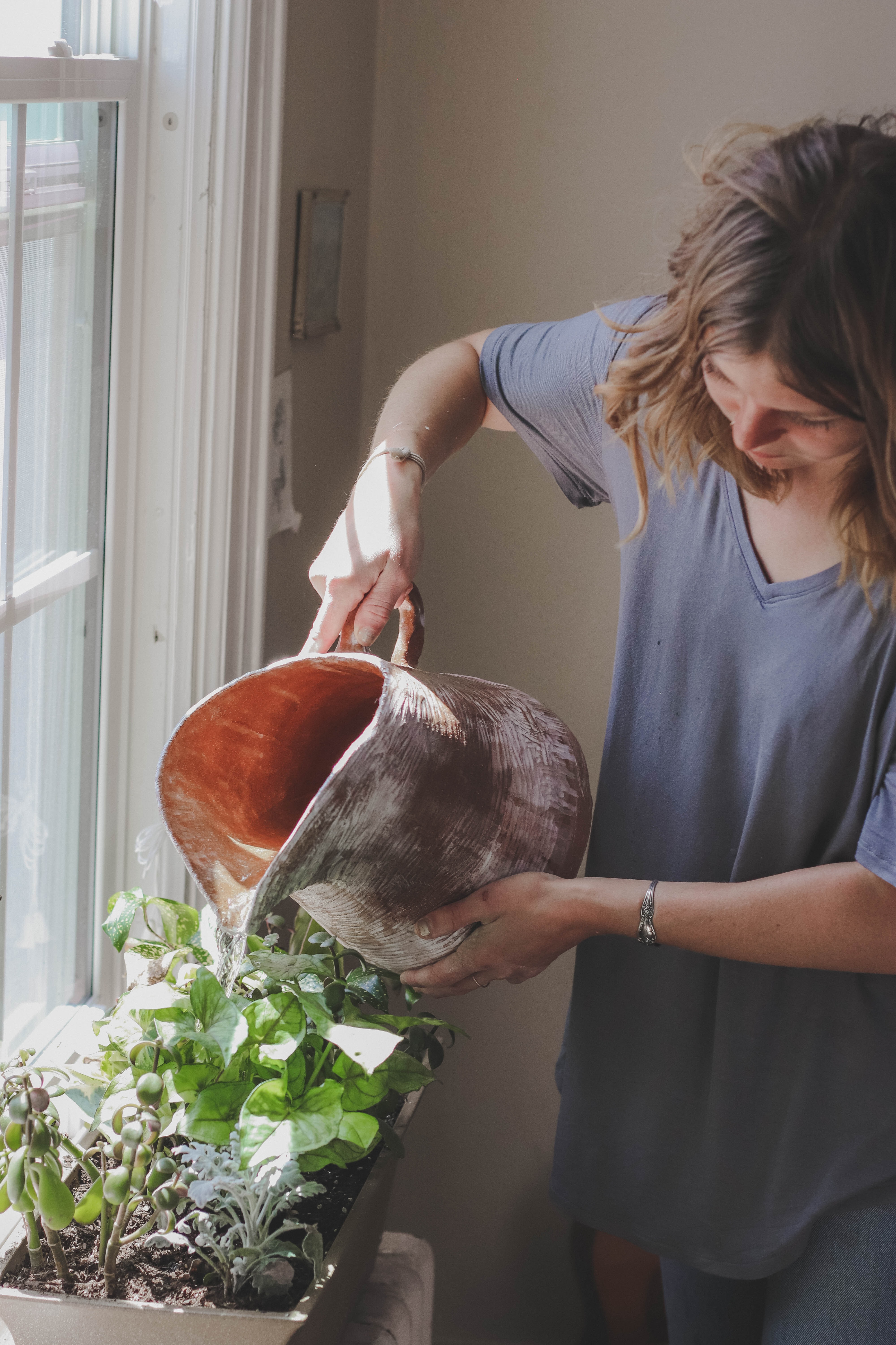 woman watering houseplants